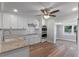 Modern kitchen featuring white cabinets, granite countertops and stainless appliances at 588 Highway 630 E, Frostproof, FL 33843