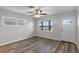 Bright living room with new floors, a ceiling fan and a front door at 588 Highway 630 E, Frostproof, FL 33843