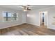 Bright living room with new floors, a ceiling fan and a front door at 588 Highway 630 E, Frostproof, FL 33843