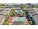Aerial view showcasing community pool and tennis courts, surrounded by lush landscaping at 6108 Curry Ford Rd # 116, Orlando, FL 32822