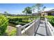 Scenic community with winding waterway crossed by a wooden bridge, lush landscaping at 6108 Curry Ford Rd # 116, Orlando, FL 32822