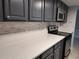 Kitchen featuring modern white countertops and backsplash with stainless steel appliances at 6108 Curry Ford Rd # 116, Orlando, FL 32822