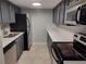 Updated kitchen with stainless steel appliances, painted cabinets, and stone countertops at 6108 Curry Ford Rd # 116, Orlando, FL 32822