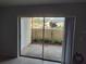 View of the back patio space with vegetation and a wall at 6108 Curry Ford Rd # 116, Orlando, FL 32822