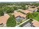 Aerial view of a lovely home with a screened-in pool nestled in a neighborhood with mature trees and green lawns at 6426 Montclair Bluff Ln, Windermere, FL 34786