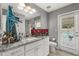 Modern bathroom with double sink vanity, granite countertops, and a glass door leading to the pool at 6426 Montclair Bluff Ln, Windermere, FL 34786