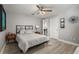 Bedroom featuring a ceiling fan, doorway to bath, and calming neutral colors at 6426 Montclair Bluff Ln, Windermere, FL 34786