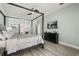 Bedroom featuring a four poster bed, ceiling fan and mounted flat screen television at 6426 Montclair Bluff Ln, Windermere, FL 34786