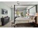 Beautiful main bedroom with four-poster bed, modern decor, and a view of the backyard pool at 6426 Montclair Bluff Ln, Windermere, FL 34786