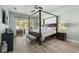 Bedroom featuring a four poster bed and sliding glass doors to the backyard at 6426 Montclair Bluff Ln, Windermere, FL 34786