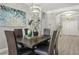 Dining area with a modern chandelier, wood table with seating for six, and stylish decorative accents at 6426 Montclair Bluff Ln, Windermere, FL 34786