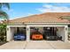 An open three-car garage showcasing sports cars with automotive decor, creating a haven for car aficionados at 6426 Montclair Bluff Ln, Windermere, FL 34786
