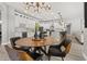 Bright kitchen with a round wooden table, modern lighting, and white cabinetry at 6426 Montclair Bluff Ln, Windermere, FL 34786