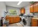 Functional laundry room with updated washer and dryer, and ample cabinet space at 6426 Montclair Bluff Ln, Windermere, FL 34786