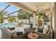 Inviting screened-in patio featuring comfortable seating, a grill, and a view of the sparkling pool area at 6426 Montclair Bluff Ln, Windermere, FL 34786