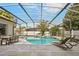 Beautiful pool area with a spa, lounge chairs, outdoor dining set, and a screened enclosure at 6426 Montclair Bluff Ln, Windermere, FL 34786