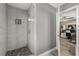 Walk-in shower features gray stone floor and subway tile walls at 6426 Montclair Bluff Ln, Windermere, FL 34786