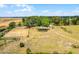 Aerial view of an equestrian estate with a horse training ring and surrounding trees at 9019 Tower Pine Dr, Winter Garden, FL 34787