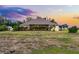 Beautiful backyard with a spacious lawn, mature trees, and a charming home at sunset at 9019 Tower Pine Dr, Winter Garden, FL 34787