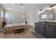 Bathroom features tiled tub, glass block wall, large mirror, and gray vanity at 9019 Tower Pine Dr, Winter Garden, FL 34787