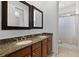 Bathroom featuring double sinks with granite countertops and a separate shower area at 9019 Tower Pine Dr, Winter Garden, FL 34787