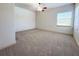 Bright, spacious bedroom featuring neutral carpet, a ceiling fan, and natural light at 9019 Tower Pine Dr, Winter Garden, FL 34787