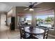 The dining area features a view of the beautiful waterfall pool and outdoor seating area creating an indoor/outdoor experience at 9019 Tower Pine Dr, Winter Garden, FL 34787