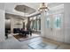 Formal dining room boasts large windows, tray ceilings, and beautiful tile flooring at 9019 Tower Pine Dr, Winter Garden, FL 34787