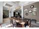 Elegant dining area connects to living area, featuring modern light and fireplace at 9019 Tower Pine Dr, Winter Garden, FL 34787
