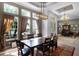 Bright dining area with large windows, elegant curtains, and modern light fixture at 9019 Tower Pine Dr, Winter Garden, FL 34787