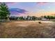 Spacious equestrian arena under a beautiful sunset, offering a serene training environment at 9019 Tower Pine Dr, Winter Garden, FL 34787