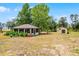 A well-kept building featuring outdoor seating areas, with a barn in a scenic setting at 9019 Tower Pine Dr, Winter Garden, FL 34787