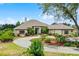 Elegant home showcases meticulously landscaped grounds and striking curb appeal at 9019 Tower Pine Dr, Winter Garden, FL 34787