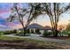 Beautiful home with mature trees, circular driveway, and stunning evening sky at 9019 Tower Pine Dr, Winter Garden, FL 34787