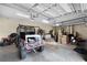 Spacious garage with ample storage space, a parked utility vehicle, and overhead lighting at 9019 Tower Pine Dr, Winter Garden, FL 34787