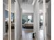 Hallway with mirrored doors reveals a glimpse into bedroom with exercise equipment at 9019 Tower Pine Dr, Winter Garden, FL 34787