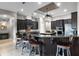 A modern kitchen features dark wood cabinets, granite countertops, and a spacious island with bar seating at 9019 Tower Pine Dr, Winter Garden, FL 34787