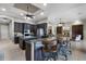 The kitchen boasts dark wood cabinets, granite counters, a center island, and an open view into the living area at 9019 Tower Pine Dr, Winter Garden, FL 34787
