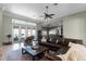 Expansive living room with tile floors, flooded with natural light, connects seamlessly to the kitchen and patio at 9019 Tower Pine Dr, Winter Garden, FL 34787