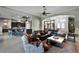 Open-concept living room flows into the kitchen with dark wood cabinets and bar seating, perfect for entertaining at 9019 Tower Pine Dr, Winter Garden, FL 34787