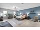 Spacious bedroom featuring blue accent wall, tile floors, area rug, and ceiling fan at 9019 Tower Pine Dr, Winter Garden, FL 34787