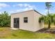 Versatile outbuilding with double doors and windows, suitable for various uses at 9019 Tower Pine Dr, Winter Garden, FL 34787