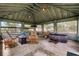 Enclosed outdoor room with hot tub, bar, hammock and seating area for relaxing outside at 9019 Tower Pine Dr, Winter Garden, FL 34787