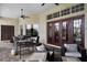 Outdoor patio with stone facade, dining area, grill, and comfortable seating beneath ceiling fans at 9019 Tower Pine Dr, Winter Garden, FL 34787