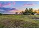 Expansive grassy property with a charming gazebo and peaceful rural setting at dusk at 9019 Tower Pine Dr, Winter Garden, FL 34787
