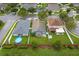Aerial view of homes in a neighborhood with green lawns and mature trees at 903 Tramells Trl, Kissimmee, FL 34744
