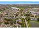 Bird's-eye view of a residential neighborhood complete with landscaped yards and glistening lakes in the background at 903 Tramells Trl, Kissimmee, FL 34744