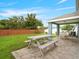 Backyard with a picnic table and seating area, and a brick fence at 903 Tramells Trl, Kissimmee, FL 34744