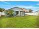 Backyard featuring a lawn, patio, and comfortable outdoor seating at 903 Tramells Trl, Kissimmee, FL 34744