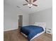 Bright bedroom with hardwood floors, vaulted ceiling, and a comfortable bed with a blue comforter at 903 Tramells Trl, Kissimmee, FL 34744
